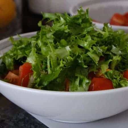 adding lettuce into salad bowl video clip